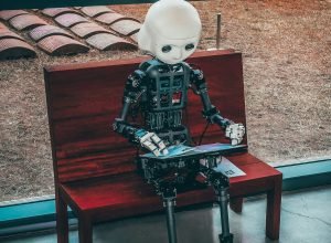 black and white robot toy on red wooden table